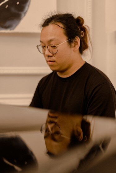 Thomas Ang, piano, with inverted rabbit,